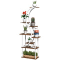 White steel and brown wood eight-tier S-shaped plant stand with potted plants on a white background