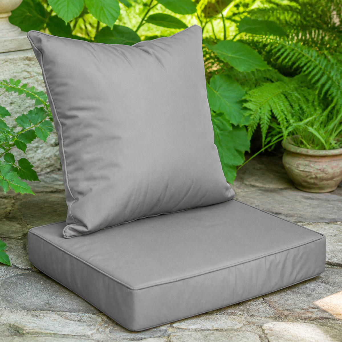 Dark-gray outdoor seat cushion and back pillow set — complementary lifestyle detail view
